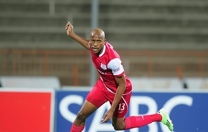 Tiyani Mabunda in action wearing a red kit