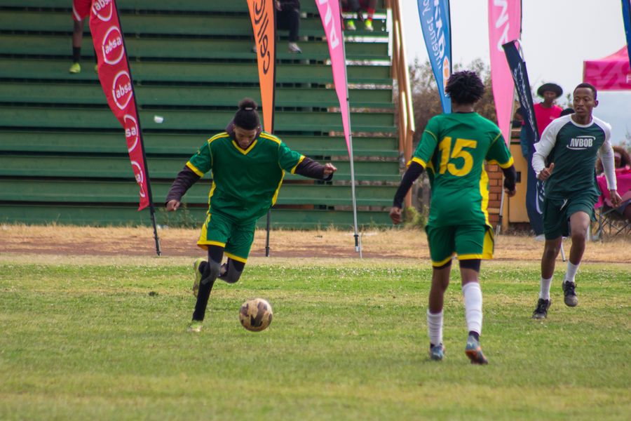 Players contest the ball in a community match