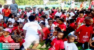 Children in red T-shirts gathered outdoors