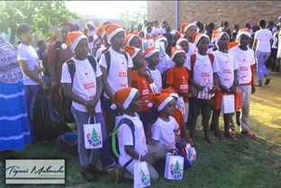 Children in Santa hats holding gift bags