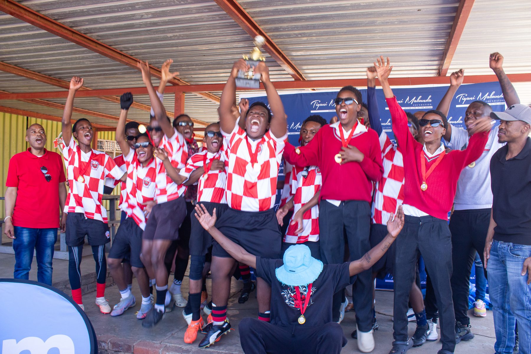 Players celebrate with the trophy at the High Schools League prize-giving