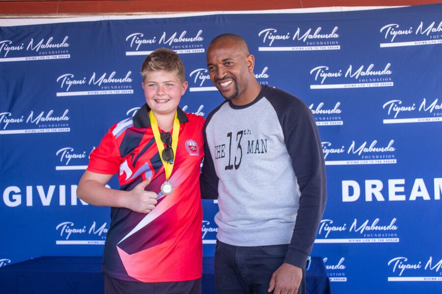A player receives his medal from Tiyani Mabunda